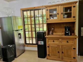 Rustic kitchen with wood cabinets and large windows in furnished house San Carlitos David Panama