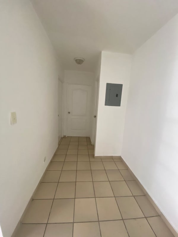 Simple hallway with white walls beige tiles electrical panel PH Carrasquilla Place Panama apartment rental
