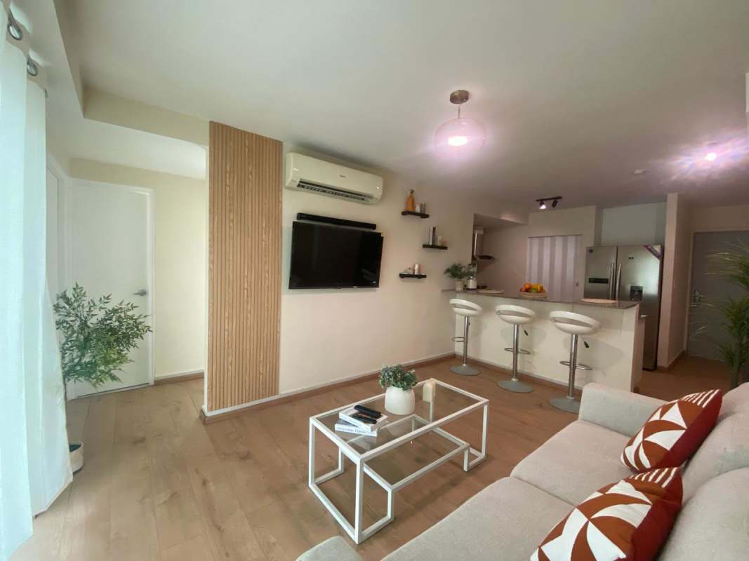 Bright living/dining room with balcony access and city views at PH Sky Business Center Panama City