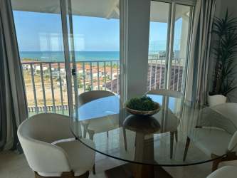 Bright dining space with balcony access and Pacific Ocean views in Buenaventura penthouse