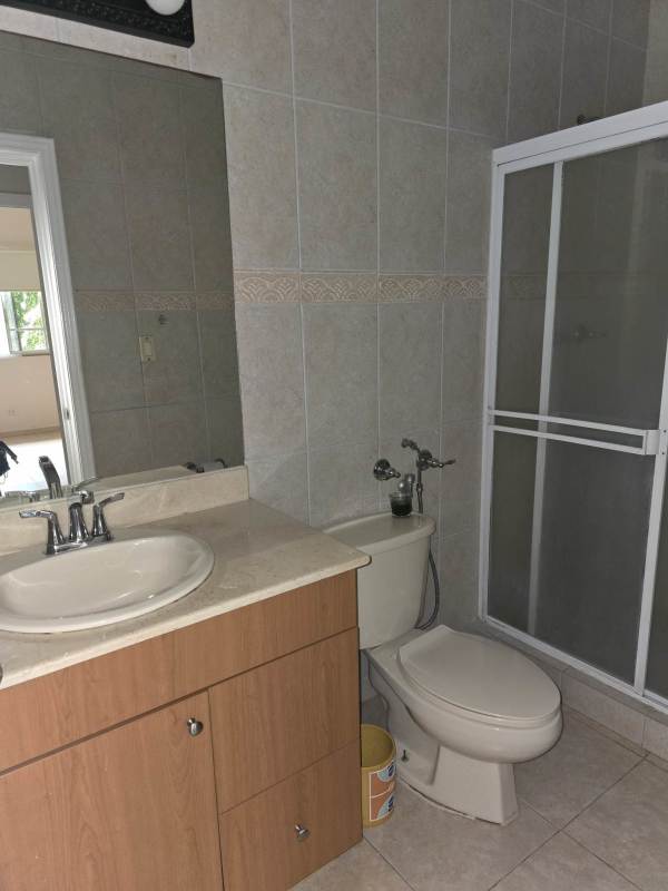 Large master bedroom with ceiling fan, tiled floors, and arched window in duplex house Palmeras Costa del Este