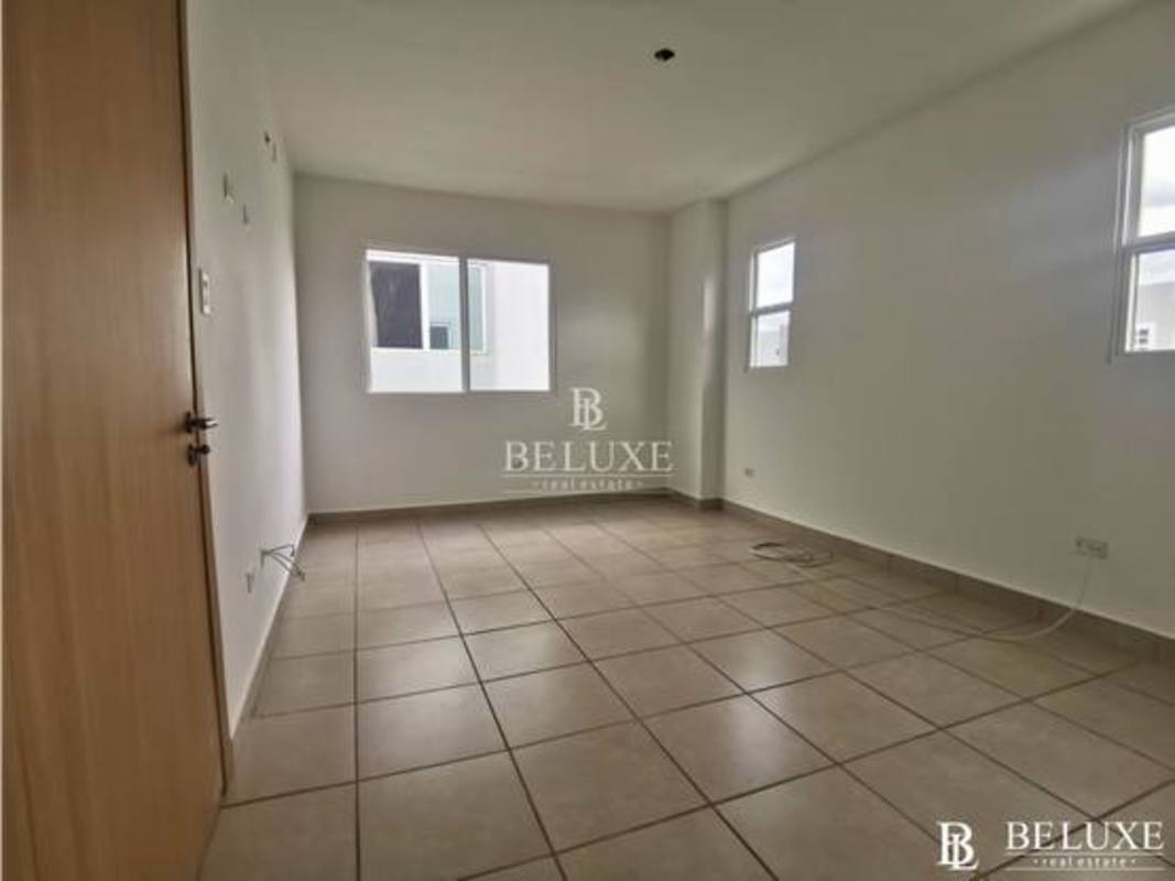 Living room with large windows and ceramic tile floors in PH Victoria house Brisas del Golf Panama