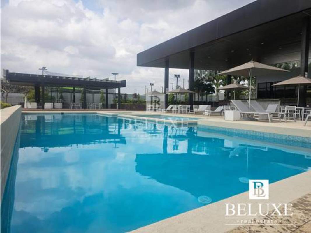 Modern outdoor swimming pool with lounge at PH Victoria Panama City