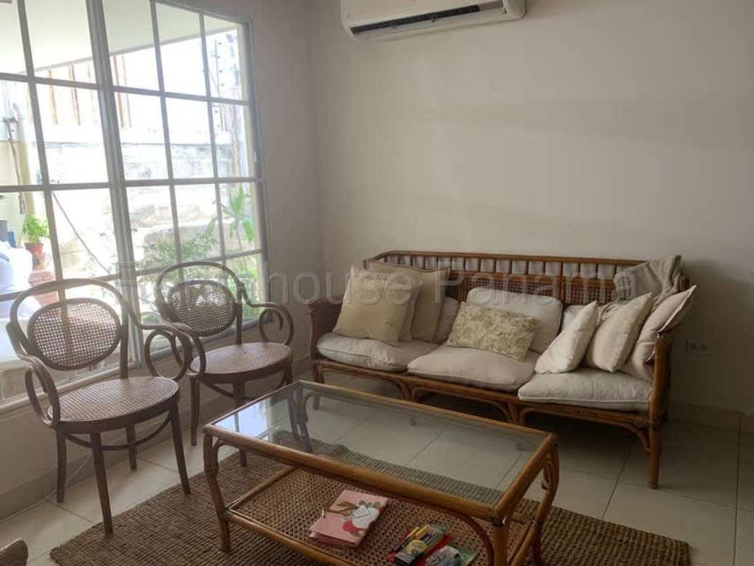 Bright living room with rattan furniture, tiled floor, large window Condado del Rey Panama