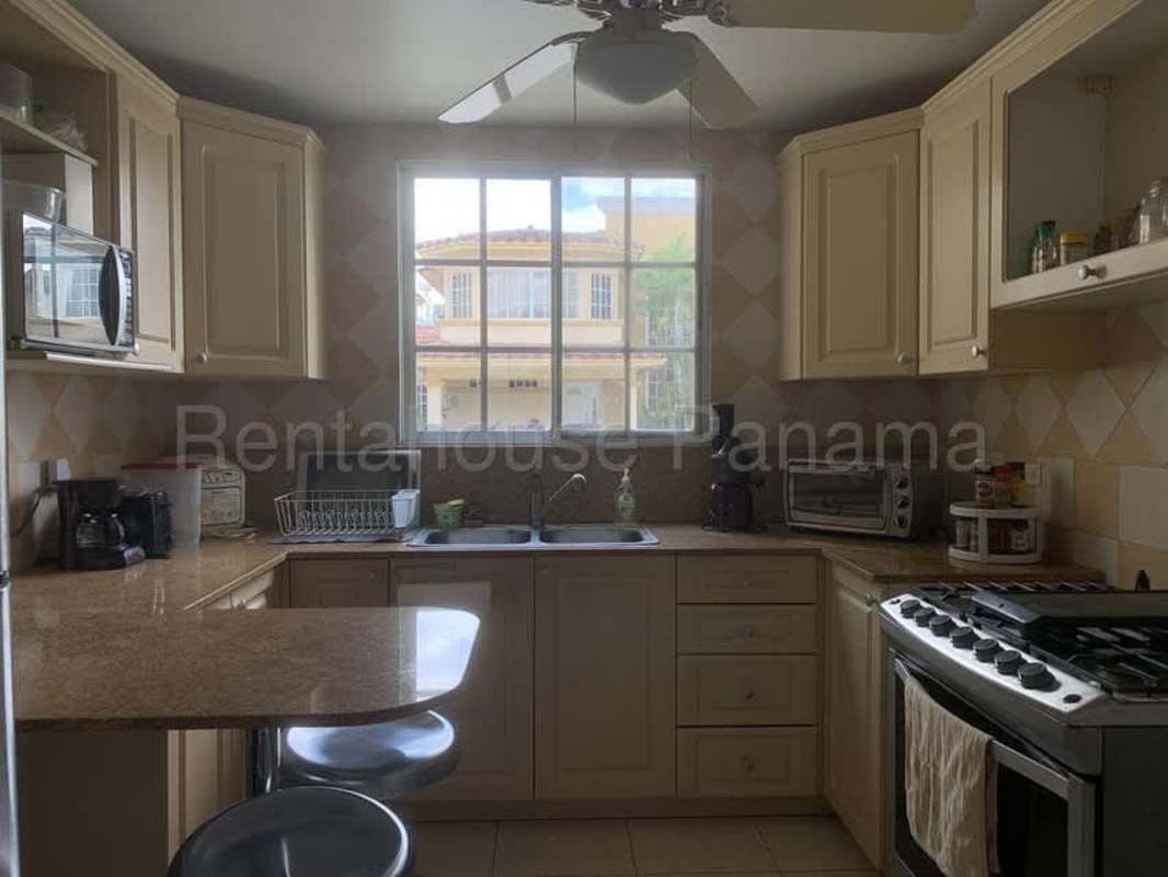 Kitchen with granite countertops, breakfast bar, gas stove and cabinets in Panama City