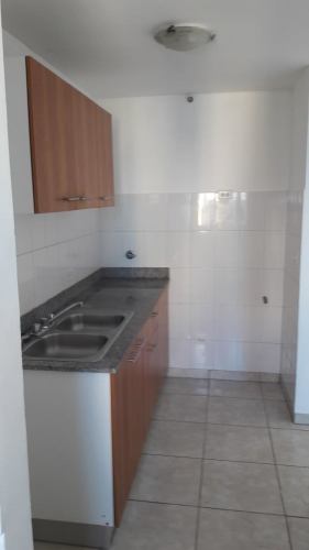 Contemporary small galley kitchen with granite countertop, wood cabinets PH Taurus Tower Carrasquilla Panama