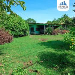 Single-story house with green yard tropical plants Atalaya Veraguas