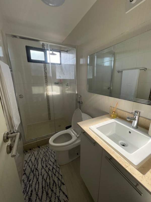 Modern galley kitchen with granite countertops, stainless appliances in PH Condado Country Club Panama