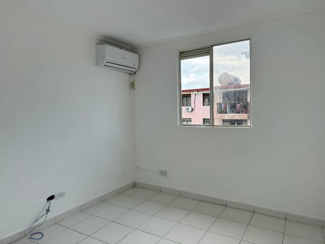 Minimalist bedroom with window tiled floors split AC Río Abajo apartment sale