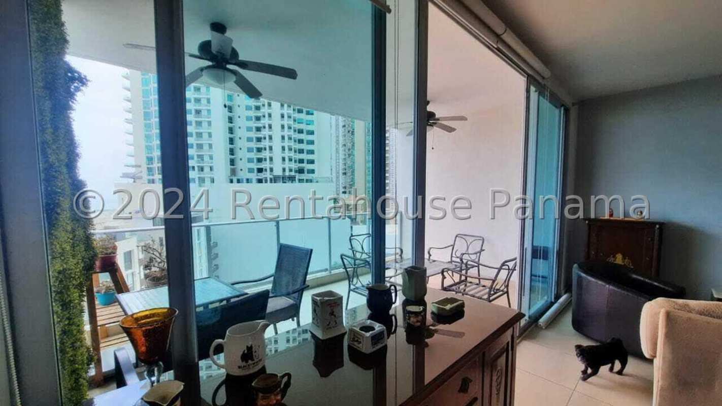 Open living dining area with floor-to-ceiling windows towards balcony and ocean in PH Dupont Tower Panama
