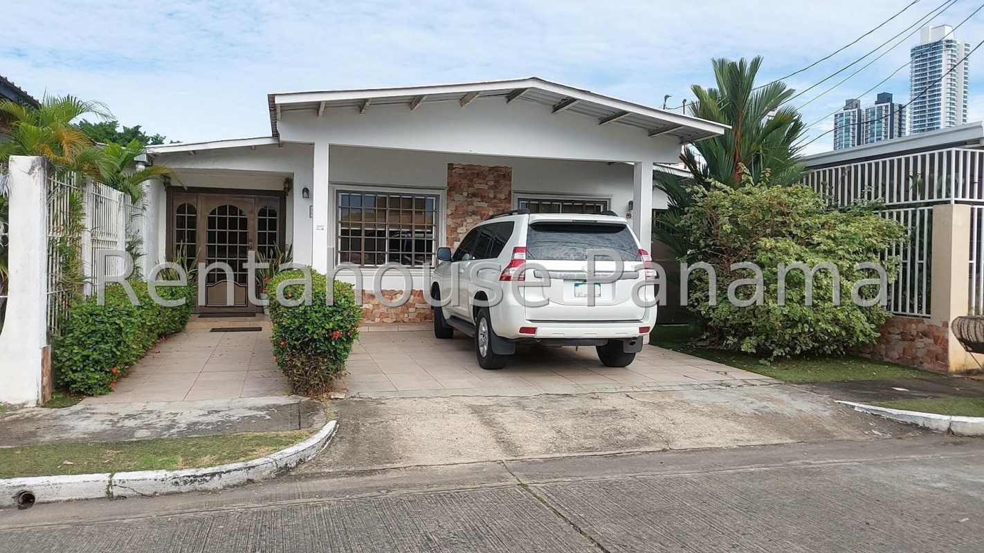 Single-story house exterior with covered carport white fence and landscaping in La Fontana Chanis