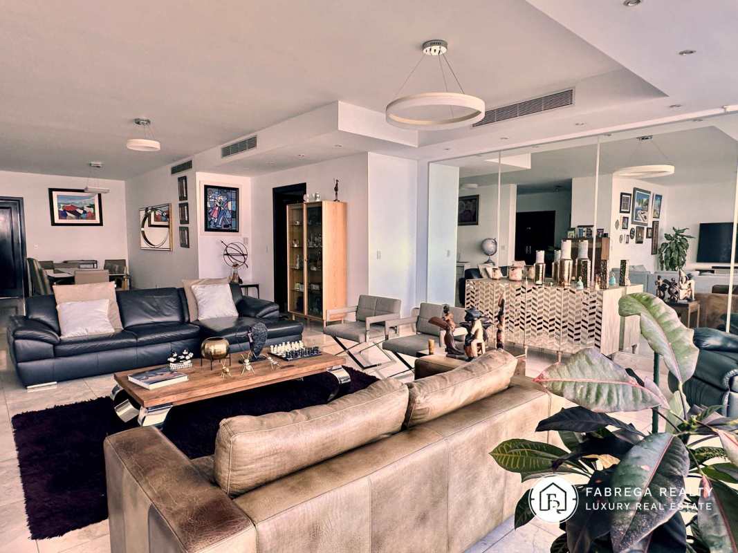 Contemporary kitchen with granite countertops, stainless appliances, and breakfast area in Vitri Tower Panama