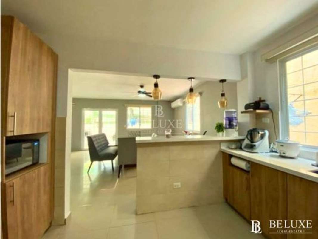 Outdoor patio bar area with wood pergola overlooking garden at Residencial El Doral Panama