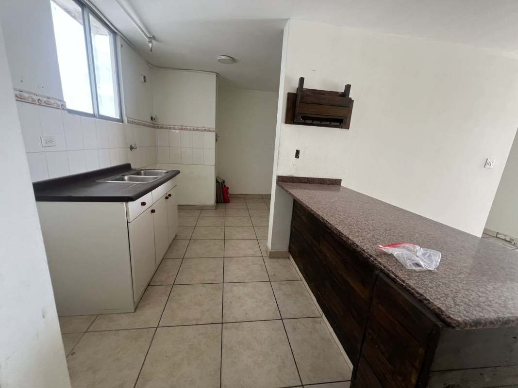 Main living area of apartment with tiled floor and window light in PH Plaza Valencia Panama City