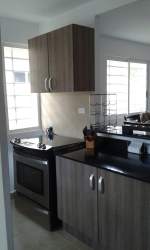 Covered front porch with pergola style wood beams and tropical plants C Paradise Coronado Panama