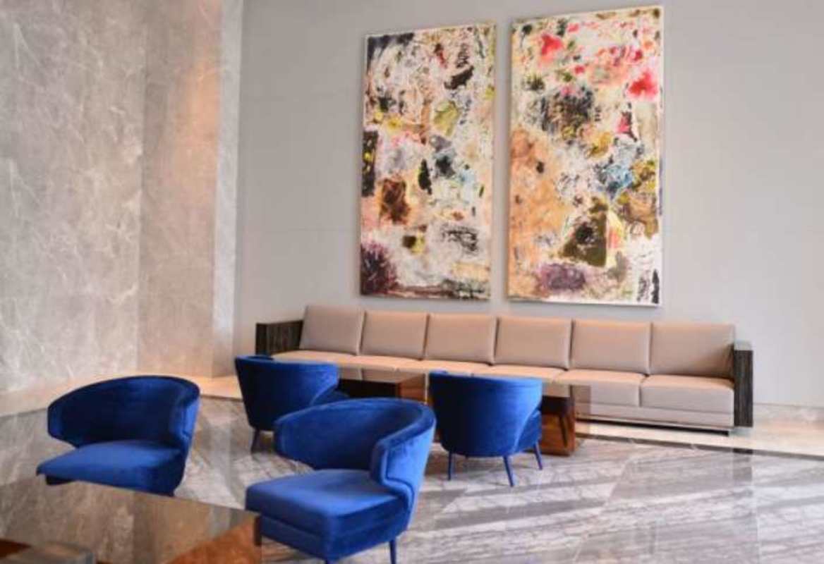 Spacious bedroom with large windows, marble flooring overlooking golf at PH Empire Residences Panama