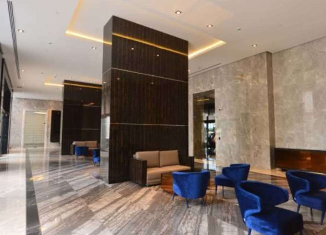 Luxury lobby with marble floors and blue velvet chairs at PH Empire Residences in Santa María Panama