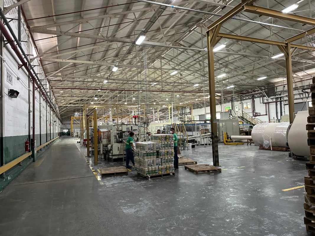 Interior industrial hall with machinery and conveyor systems in La Loceria warehouse Panama