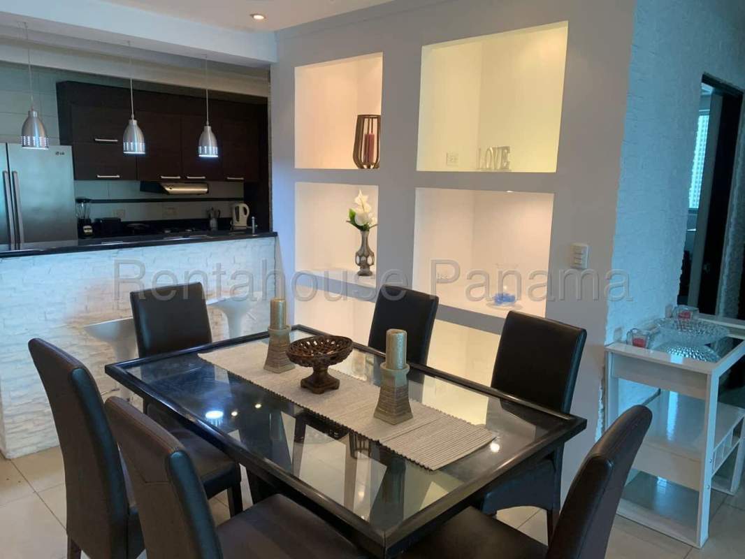 Glass dining table, open kitchen design with pendant lighting in PH Plaza Paitilla Punta Paitilla