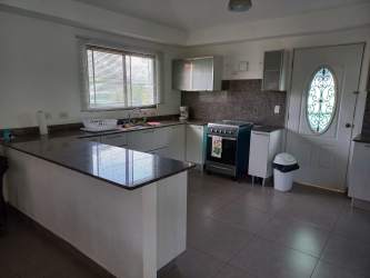 Covered terrace overlooking private tropical garden in Coronado beach house Panama