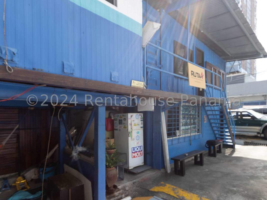 Blue two-level industrial commercial structure with metal siding and stairs in Panama City