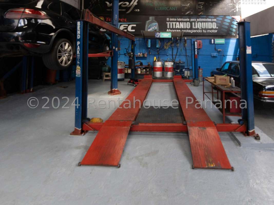 Automotive workshop interior with hydraulic car lift and service equipment in San Francisco Panama