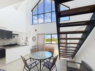 Living and dining area with vaulted ceilings, large windows, modern decor PH Brisas de Coronado Playa Coronado Panama