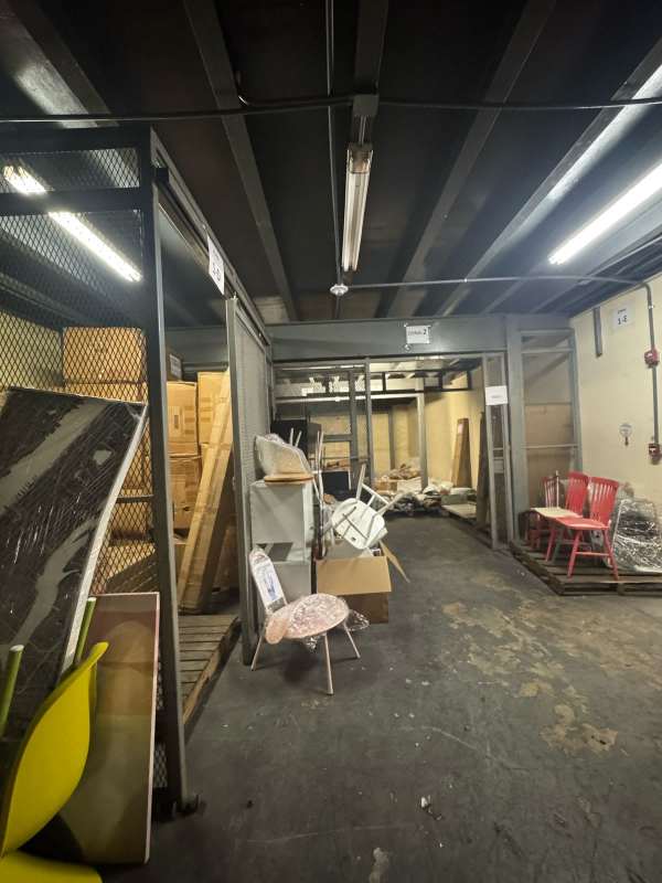Interior secured storage area with metal cages and industrial lighting, warehouse in Panama