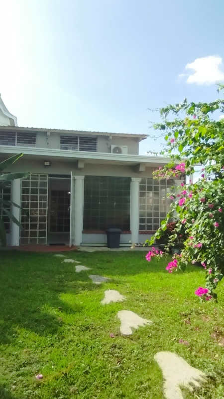 Front view of two-story duplex with balcony and carport at Club X Betania Panama