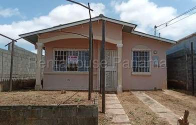 Bungalow home with iron window bars front porch fenced yard in Panama Oeste La Chorrera