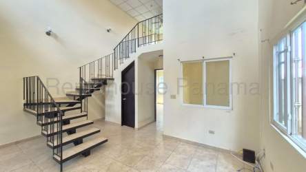 Loft-style living-dining room with staircase at townhouse La Fontana in David, Chiriquí