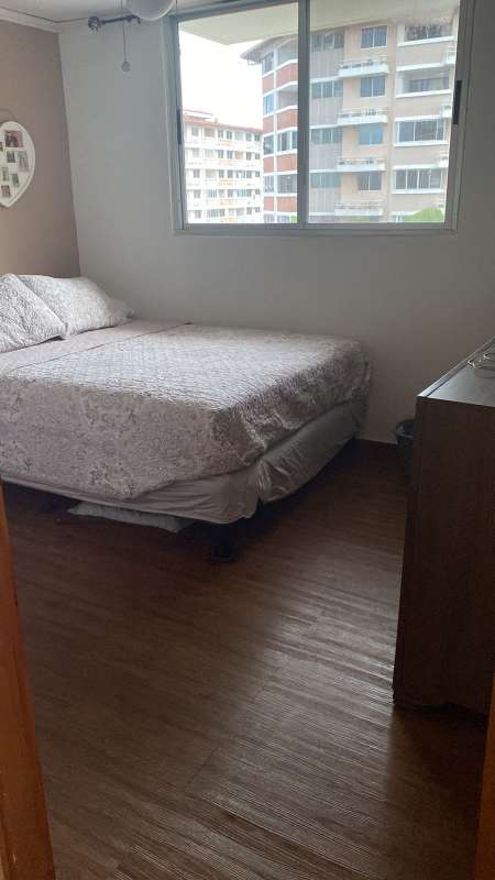 Bedroom with double bed and window overlooking city PH Llano Bonito Panama