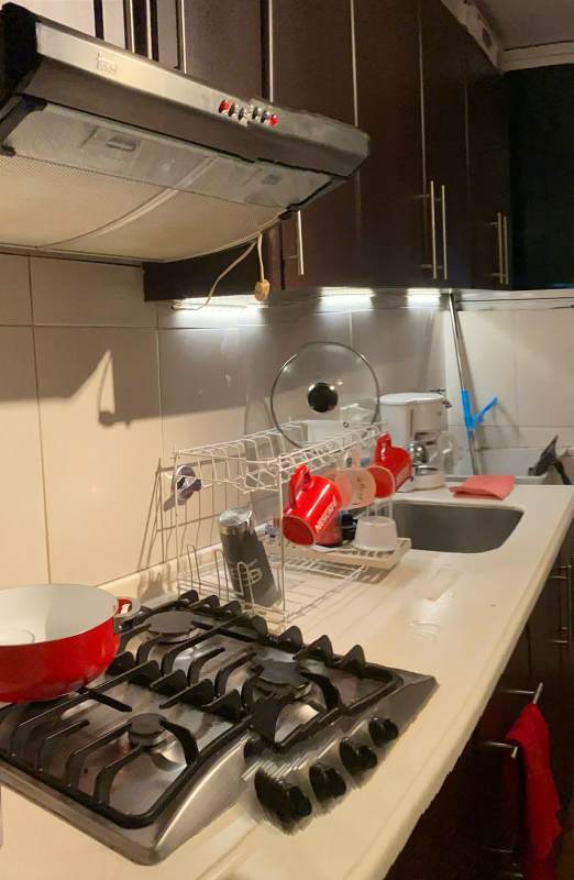 Compact kitchen with gas stove and dark cabinets PH Llano Bonito Panama