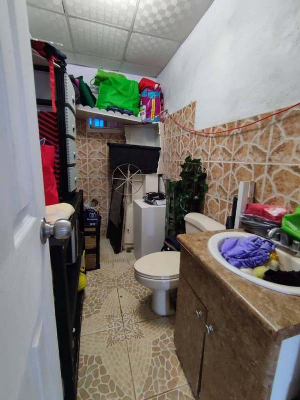 Bedroom interior with tile floors window overlooking green yard Pacora Panama