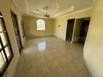 Living room in two-story home with arched windows, tile floor and decorative ceiling in La Chorrera Panama