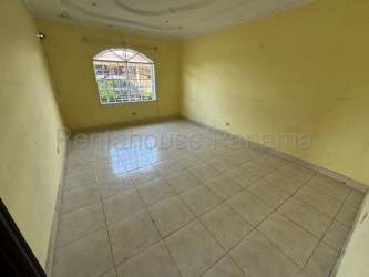 View of backyard swimming pool with tiled patio and privacy fence at La Chorrera house