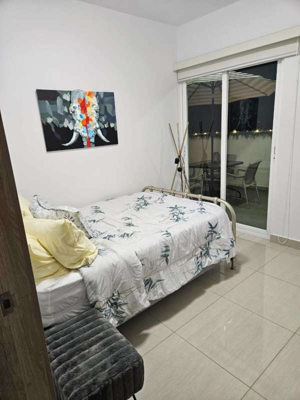 Modern balcony at night with patio set and city skyline view at PH 43 GV Panama