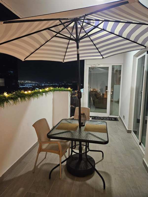 Spacious balcony with striped umbrella, patio seating and ocean views PH 43 GV Panama City