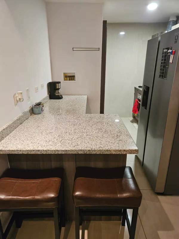 Laundry with washer dryer, tile walls and storage at PH 43 GV Panama City rental