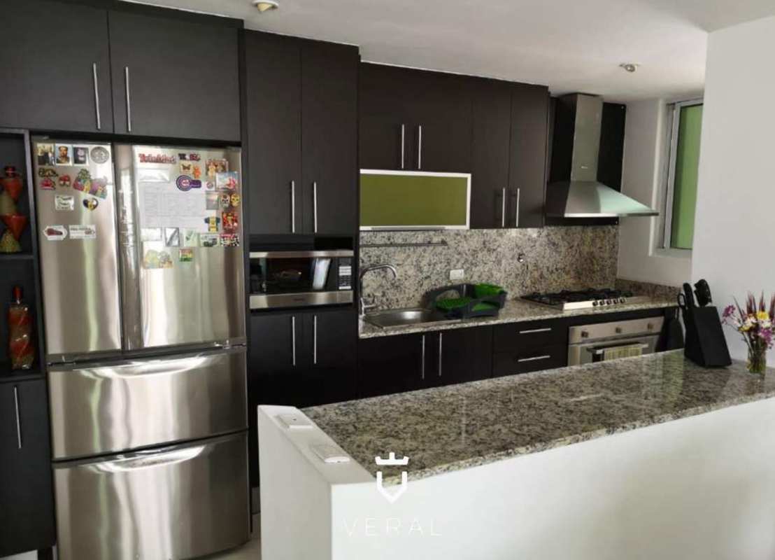 Open modern kitchen with granite countertop and stainless steel appliances PH Terramar Panama