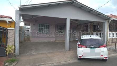 Exterior view with covered carport and decorative window bars house in Valle Dorado La Chorrera Panama