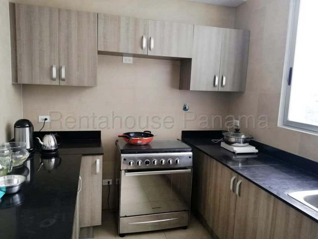 Contemporary kitchen with granite countertops, ample cabinetry and window at The One Tower Panama