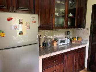 Kitchen with granite top wooden cabinets fridge in Boquete Panama furnished house