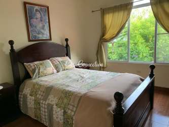 Dining room with large window stone wall chandelier garden views in Boquete Panama