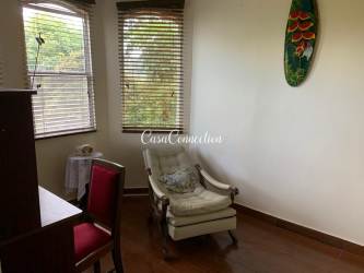 Furnished kitchen with wooden cabinets gas stove and window in mountain house Boquete Panama