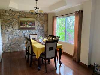 Traditional bedroom with four-poster bed pink curtains and mountain views in Boquete Panama