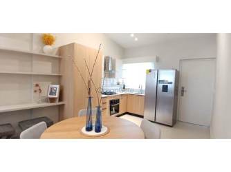 Bright kitchen with wood cabinetry in beach residence Soleil Playa del Sol San Carlos