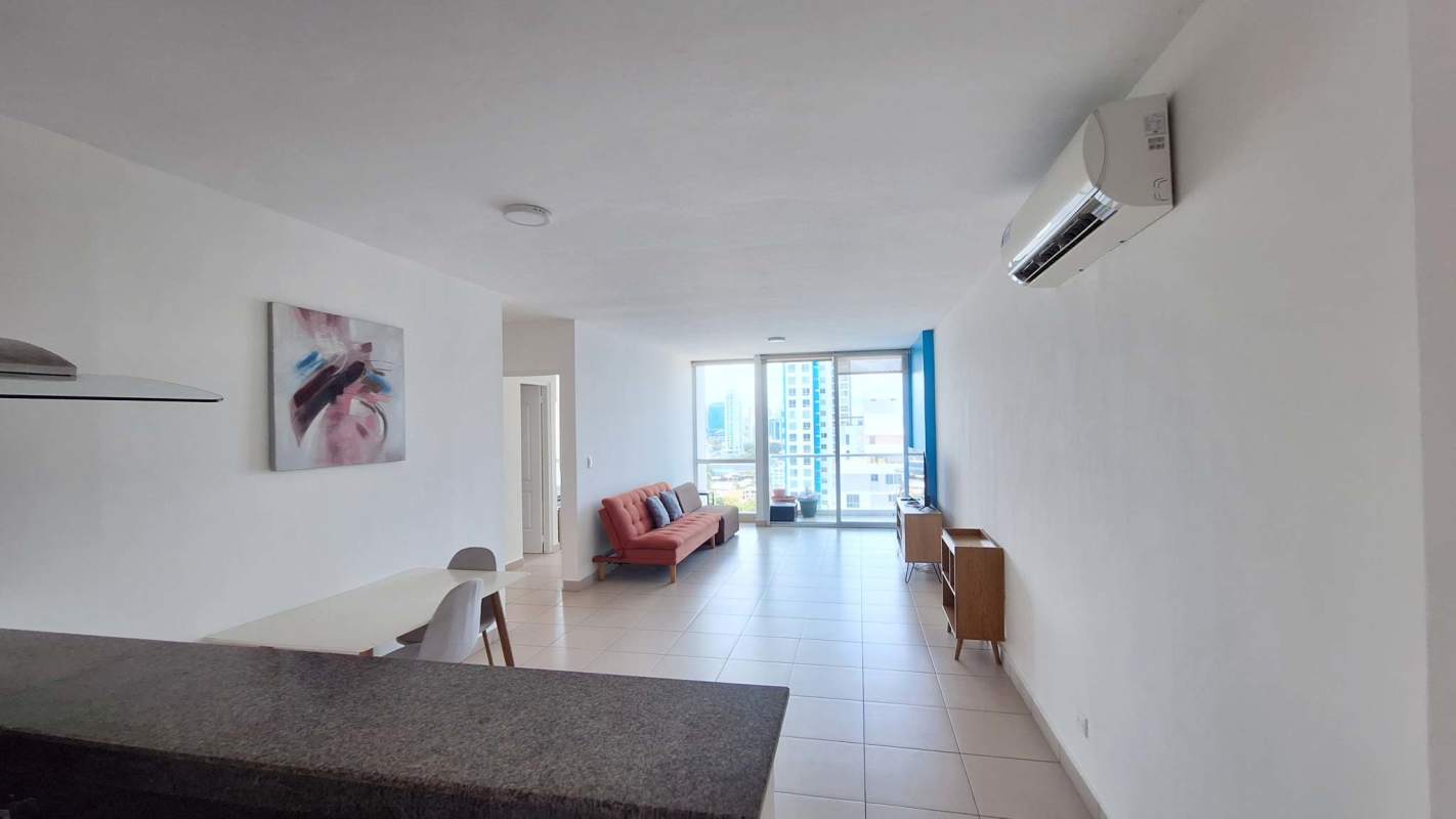 Open-concept living room with balcony and large windows with city view in PH Met One Panama City