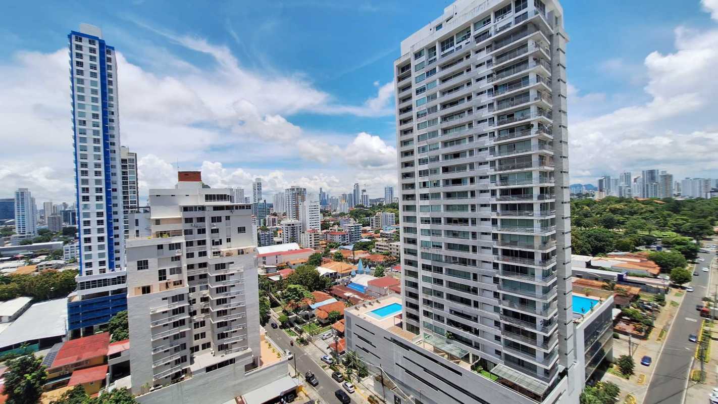 Aerial photo of PH Met One tower facade with rooftop pools and skyline view
