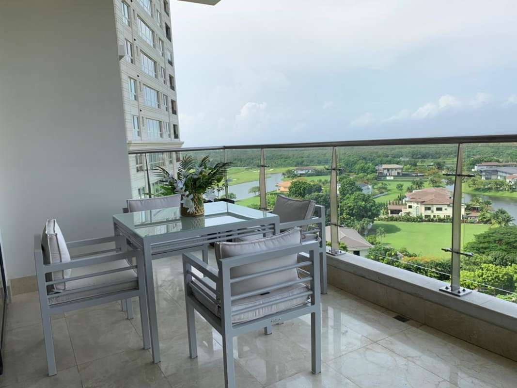 Spacious living room with floor-to-ceiling windows and terrace access overlooking Santa Maria golf course in La Vista on the Green, Panama City